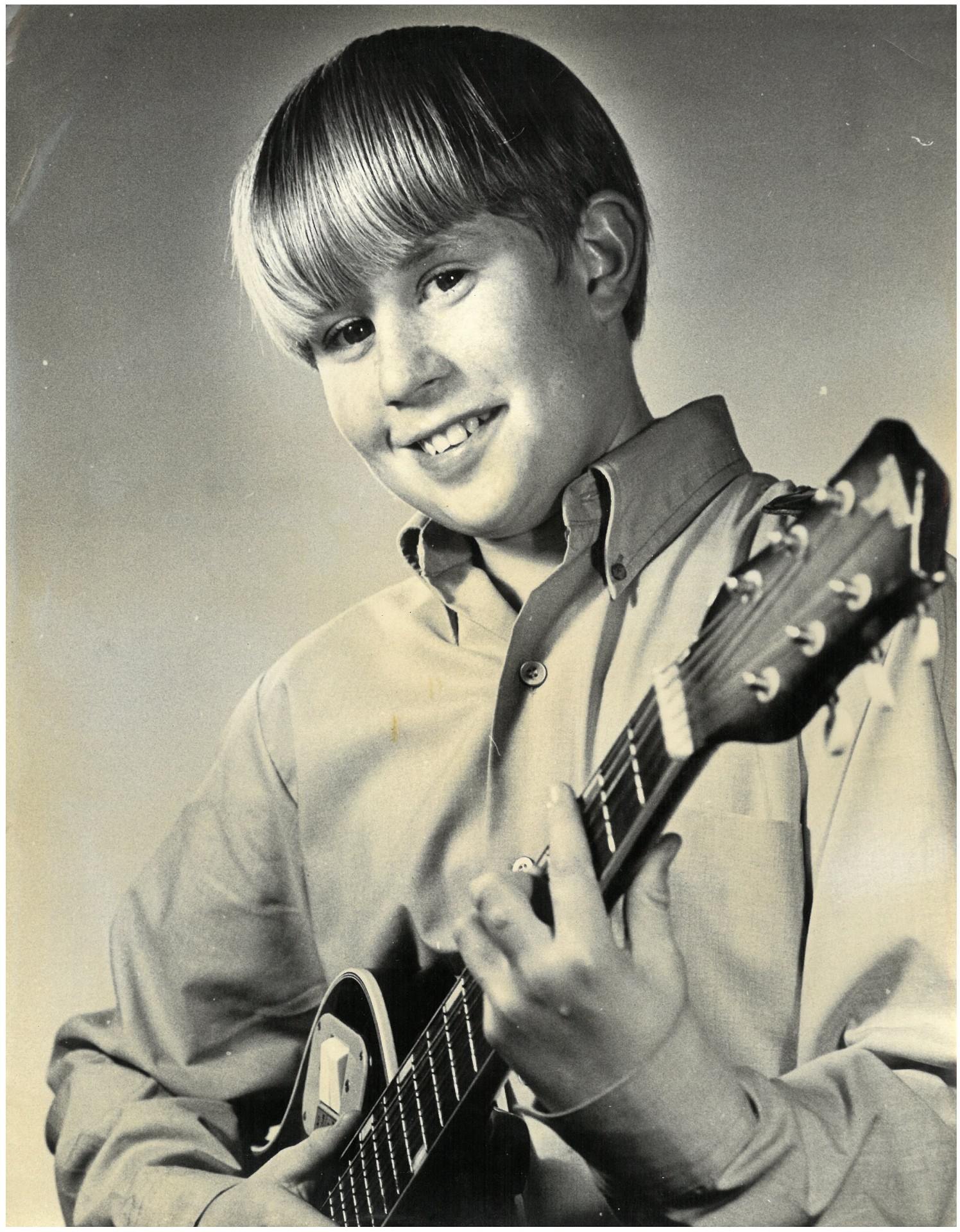 David Curtis as a young boy with his guitar